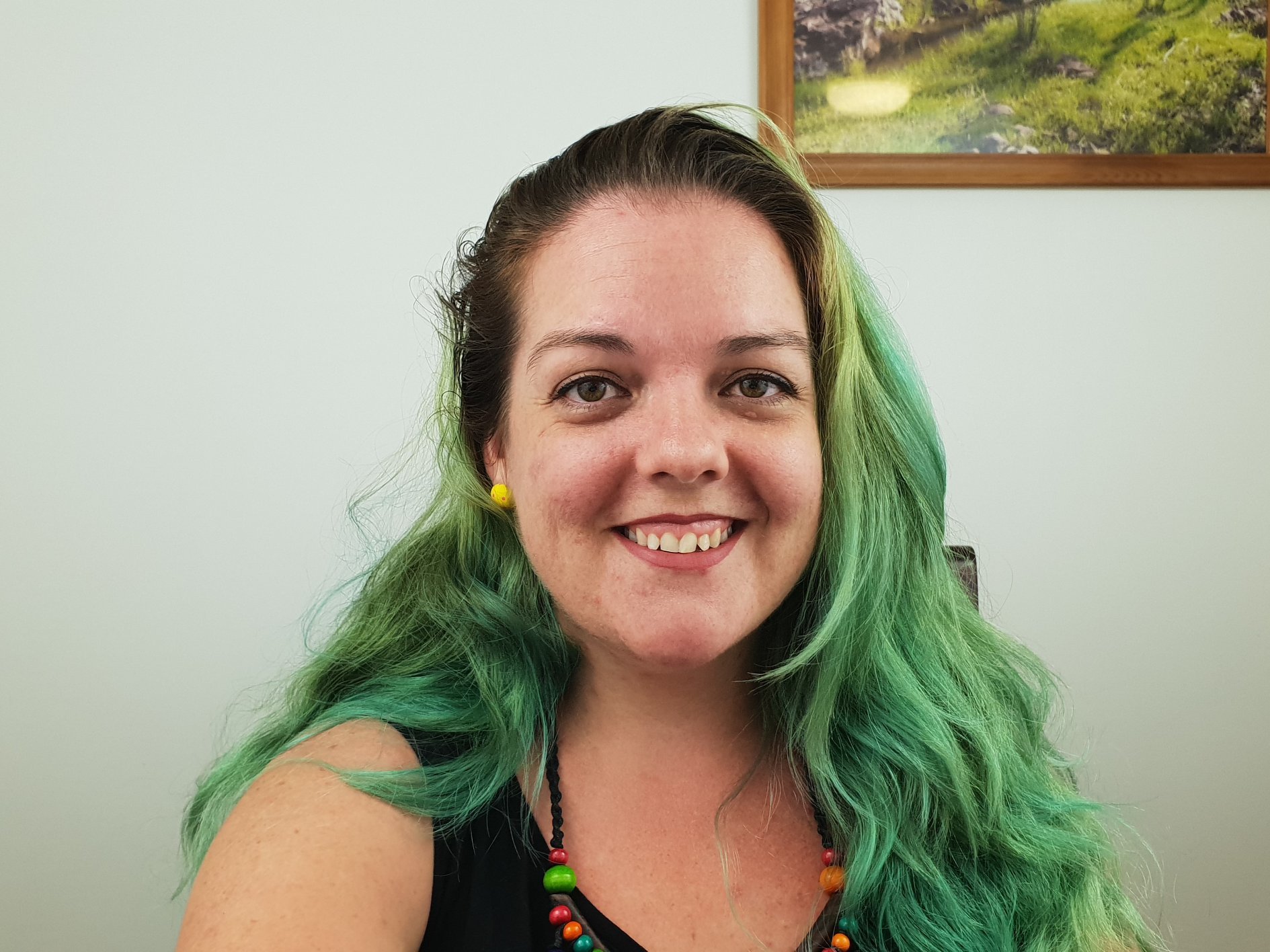 image of female, smiling, with green hair